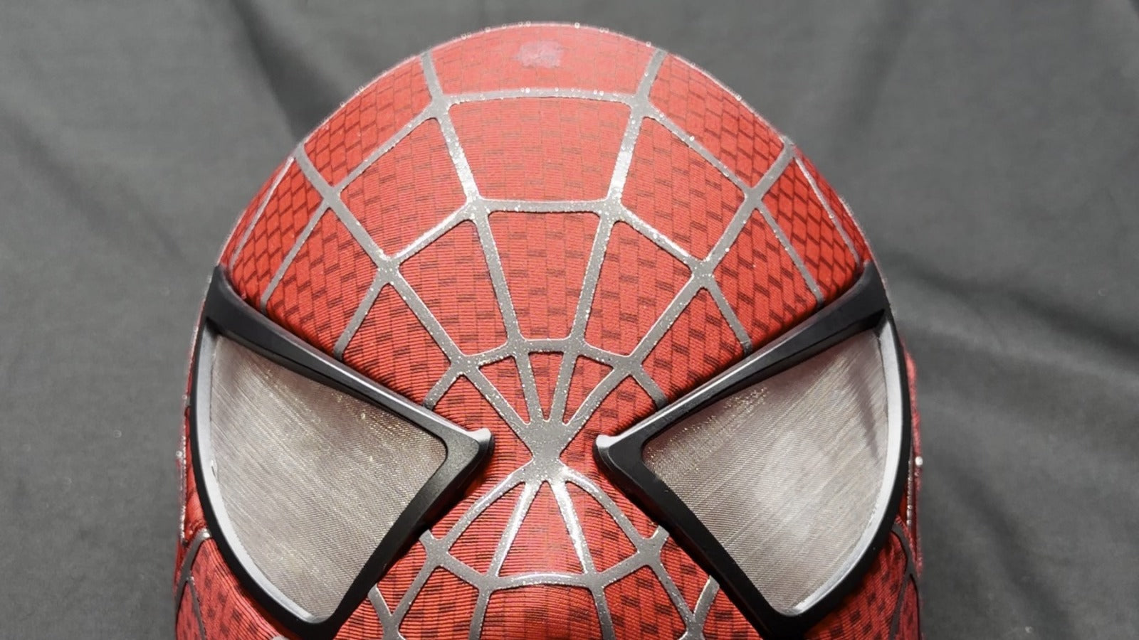 Completed eye-frame alignment on a handcrafted red web cosplay mask